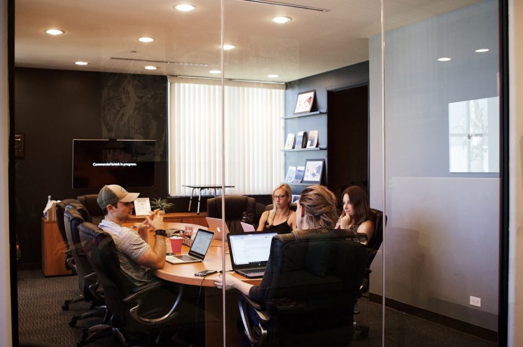 people-sitting-near-table-with-laptop-computer-qci-mzvodou