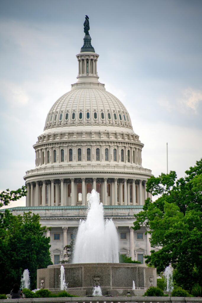 US Capitol Building with fountain in the foreground, iconic DC landmark.